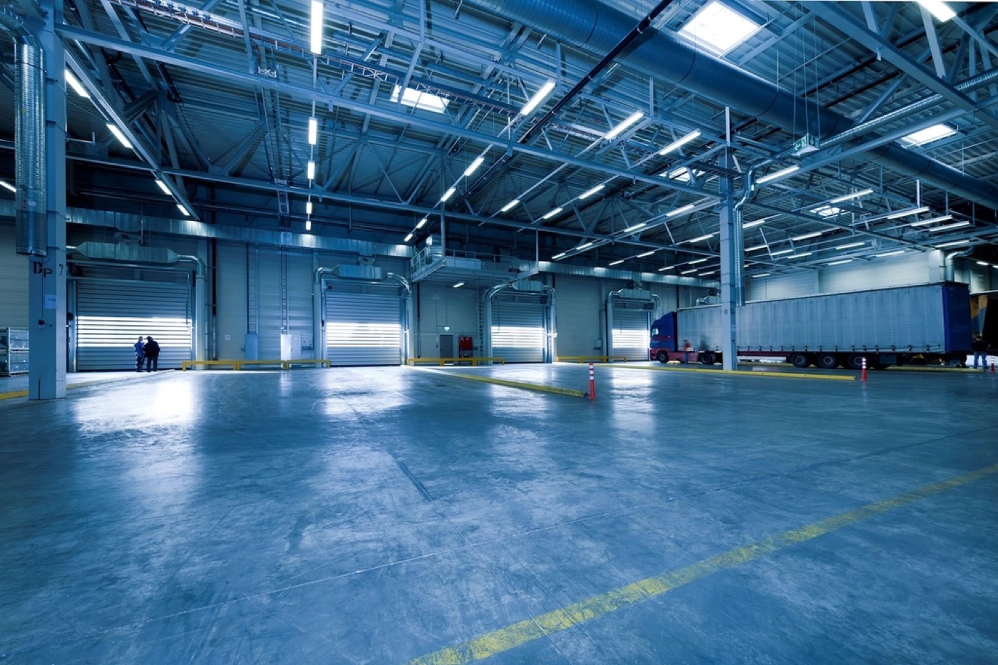 Distribution center loading dock with trailer bays and a freight truck ready for dispatch