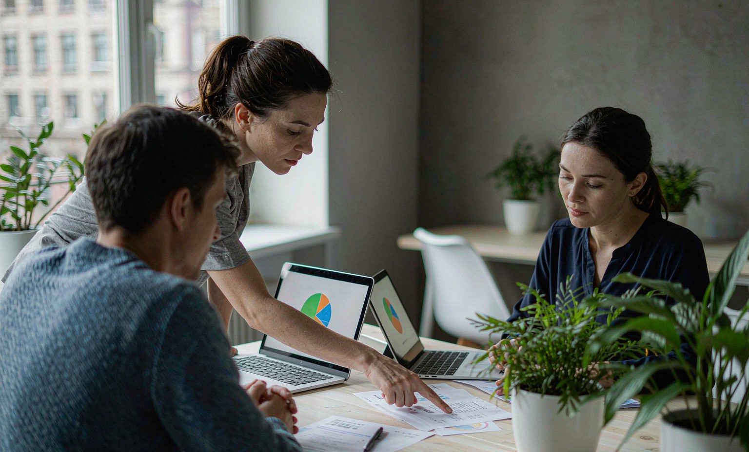 Team reviewing inventory reports and sales data around a meeting table