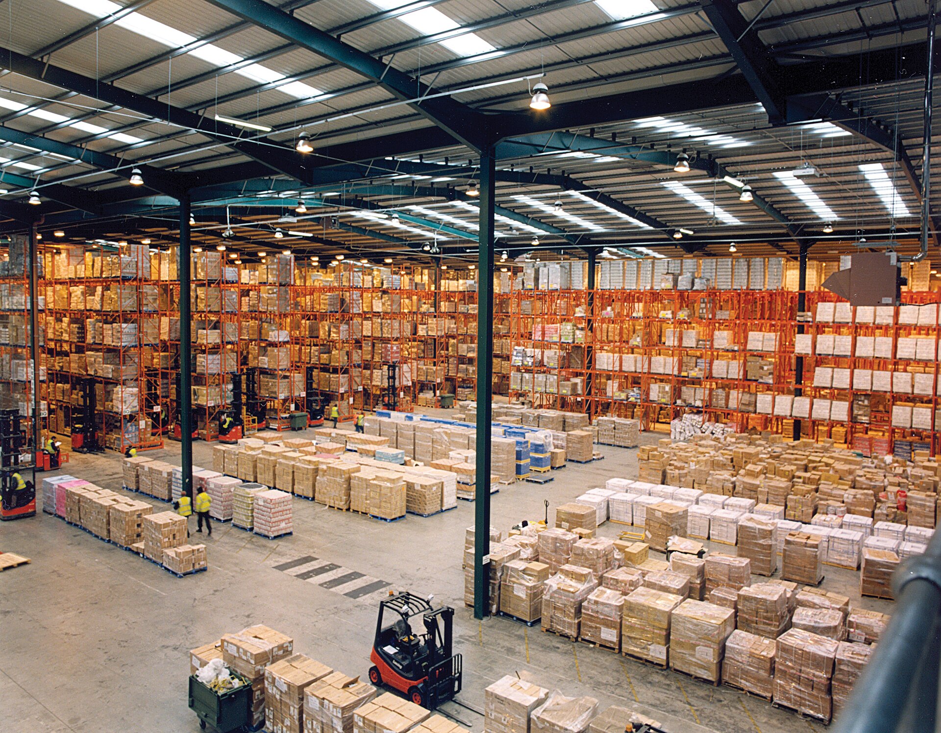Large warehouse interior with tall pallet racking filled with boxes